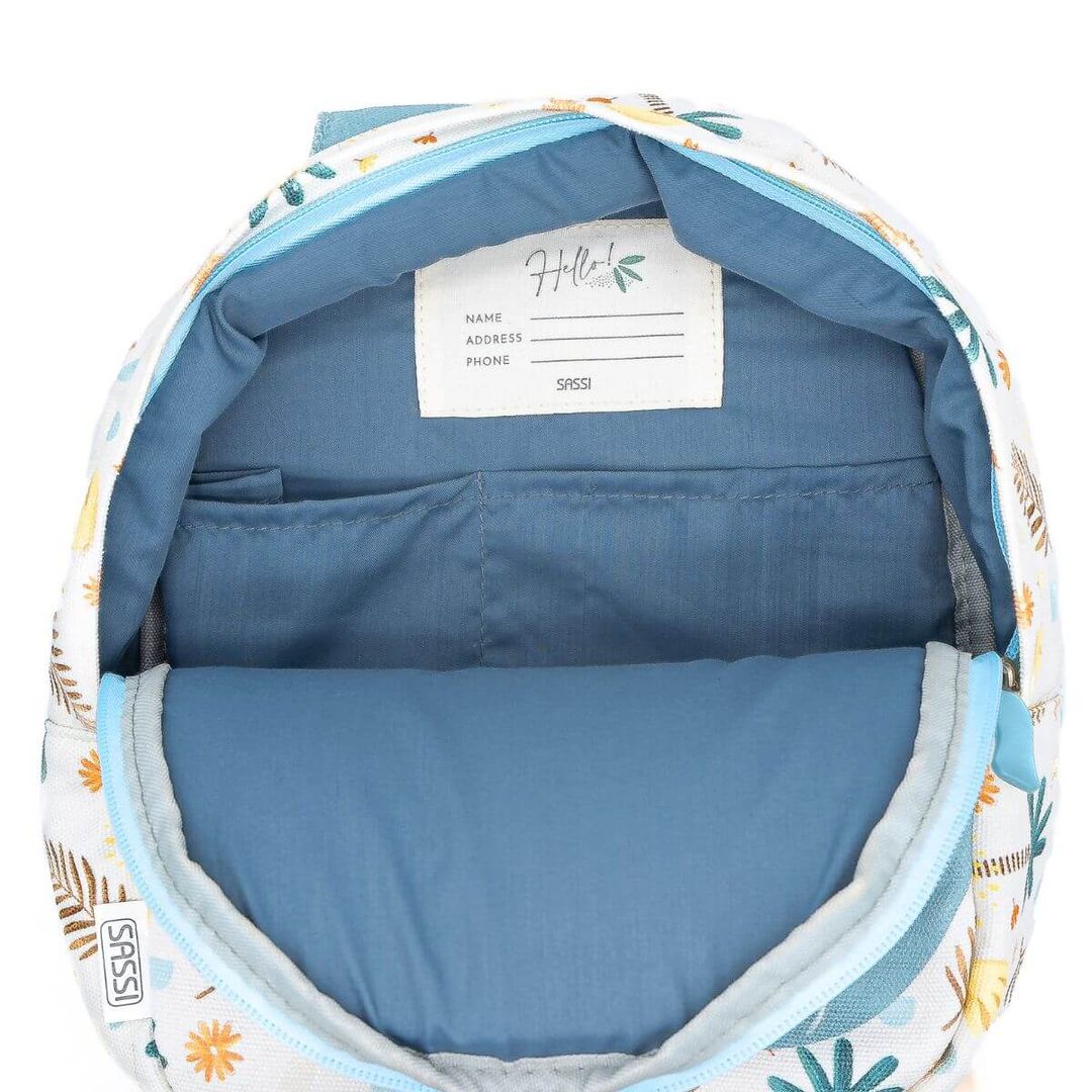Open Sassi backpack, white with floral pattern, blue lining and name tag detail.