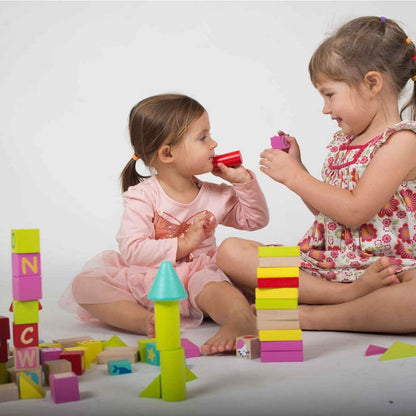niñas jugando con bloques en madera para primeras construcciones