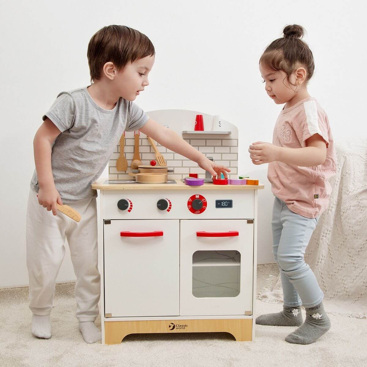 dos niños jugando con la cocinita de madera Cocina del Chef Classic World
